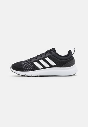 Zapatilla de running Adidas en blanco y negro con tres franjas blancas, parte superior de malla, cuello de talón acolchado y suela blanca acolchada.