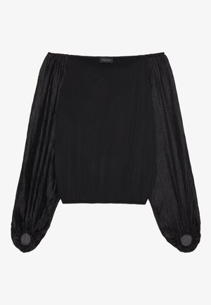 Svart topp med en tettsittende kropp og voluminøse, gjennomsiktige ermer. Stoffet er glatt på kroppen og teksturert for ermene, med elastiske mansjetter.