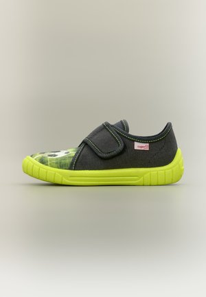Child’s dark gray shoe with a bright yellow sole, green stitching, Velcro strap, and a soccer ball print on the toe.