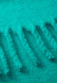 Turquoise felt fabric with a textured, fuzzy surface featuring uneven, raised stripes and a soft, wool-like appearance.