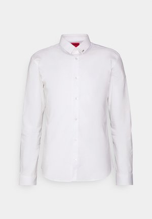 White long-sleeve button-up shirt, featuring a collar, front pocket, and shiny buttons, made from smooth cotton fabric.