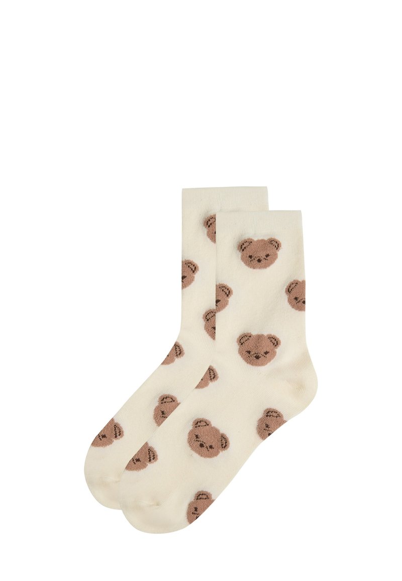 Cremefarvede sokker med en blød tekstur, prydet med et gentaget mønster af brune teddy-bjørne. Behageligt og afslappet design.