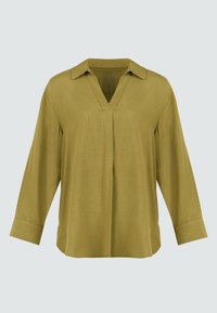 Blusa verde oliva a maniche lunghe con scollo a V e colletto. Realizzata in materiale leggero e testurizzato; presenta una vestibilità morbida e spacchi laterali.