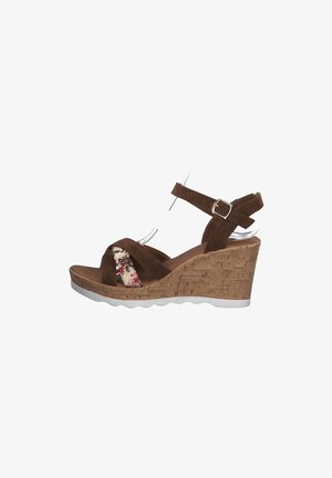 Brown suede wedge sandal with floral accent and adjustable strap. Cork platform with a white rubber sole; open toe design.