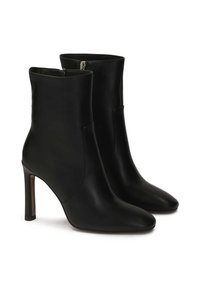 Black leather ankle boots with high stiletto heels, pointed toes, smooth texture, and side zipper closures. No visible patterns or accents.