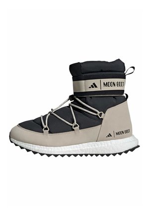 Botte montante Moon Boot avec tige rembourrée noire, accents beige, lacets blancs, semelle blanche rembourrée et bandes à logo autour de la cheville et du talon.