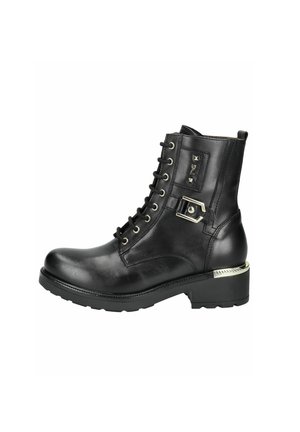 Black leather ankle boot with lace-up front, metal accents, and a thick rubber sole. Features a decorative buckle and stud details.