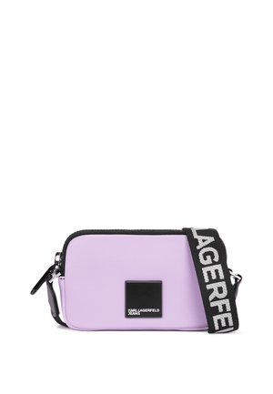 Purple synthetic leather crossbody bag with black accents, zip closure, rectangular shape, logo patch, and adjustable strap featuring brand name.