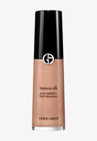 Illuminateur liquide rose doré dans un flacon transparent élégant avec un bouchon noir brillant. Présente un logo circulaire et une étiquette à l'avant.