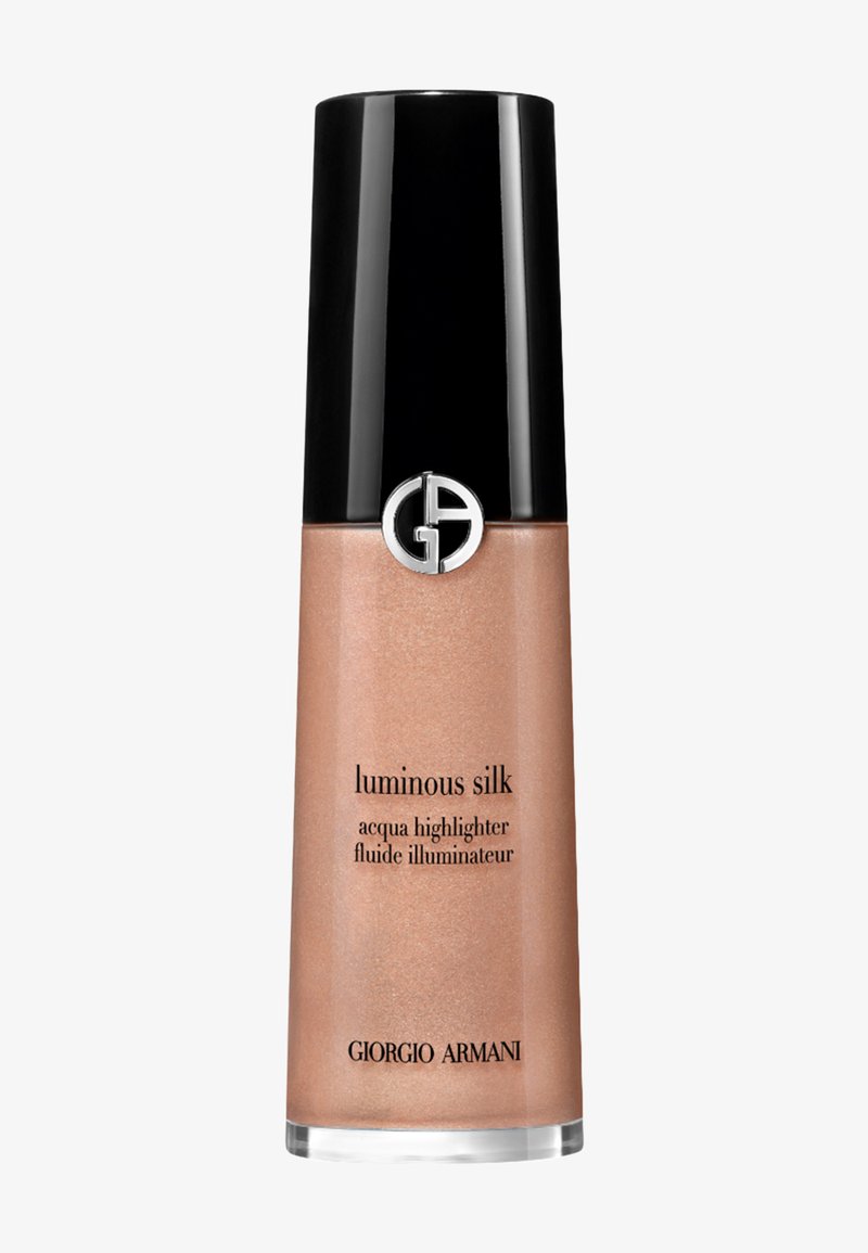 Roze gouden vloeibare highlighter in een slanke, transparante fles met een glanzende zwarte dop. Bevat een circulair logo en een gelabelde voorkant.
