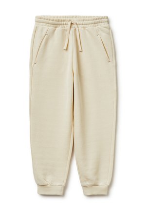 Pantaloni della tuta beige con vita elastica, coulisse, tasche laterali e polsini a coste, distesi su sfondo bianco.