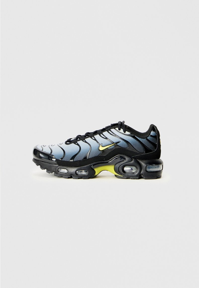 Nike Air Max Sneaker in Schwarz, Grau und Neon-Gelb mit sichtbarer Luftpolsterung und gewellten Designelementen im Obermaterial.