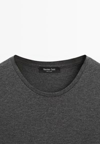 Ciemnoszary t-shirt wykonany z miękkiej tkaniny, z okrągłym dekoltem i metką z napisem „Massimo Dutti.” Gładka faktura z minimalnymi zdobieniami.