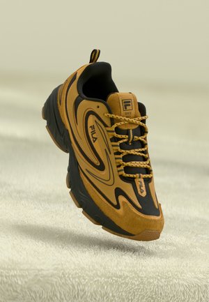 Fila sneakers with a sleek design, featuring brown suede and black accents, textured sole, and prominent lacing system.