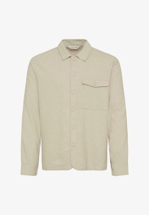 Bézs texturált anyagból készült gombos ing, gallérral, elülső zsebbel és hat kontrasztos gombbal az elején.