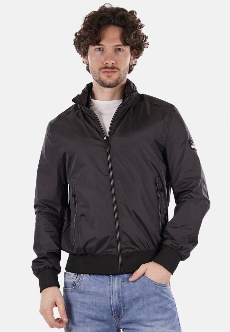 Giacca bomber nera in nylon con chiusura a zip, polsini e orlo a coste, e due tasche frontali; presenta un logo discreto sulla manica.