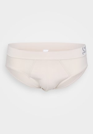 Beige men's brief with a smooth texture, elastic waistband, and stitched detailing. Features a minimalistic design without patterns.