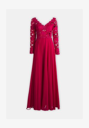 Pikk roosa kleit sügava V-kaelusega ja pikkade pitsi varrukatega. Üksikasjalik pitsist bodi üleminek sujuvatele, pehmetele seelikuosadele.