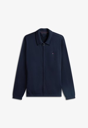 Navy zip-up jacket with a classic collar, made of soft fabric. Features a small logo on the left chest and elastic cuffs.