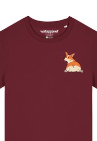 Bordeauxfarbenes T-Shirt aus Baumwolle mit rundem Ausschnitt. Mit einem Cartoon-Corgi-Graphic auf der linken Brust, das orange und cremefarbene Farben zeigt.