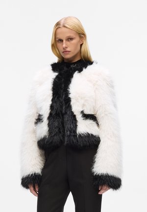 Faux fur jacket featuring a cropped design with black and white coloration, long sleeves, and a textured, fluffy finish.