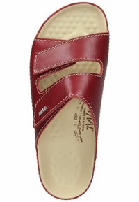 Red leather sandal with two wide straps, textured insole, and stitching accents. Features a smooth interior and cut-out details on straps.