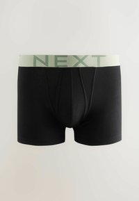 Fekete boxer alsónadrág világoszöld rugalmas derékszíjjal, amelyen a "NEXT" felirat szerepel. Simító anyagból készült, testhezálló vonalakkal és elöl zsebszerű kialakítással.