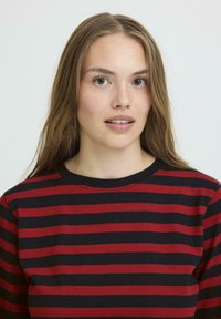 Red and black striped long-sleeve shirt with a crew neck. The fabric appears soft with a smooth texture and even pattern throughout.