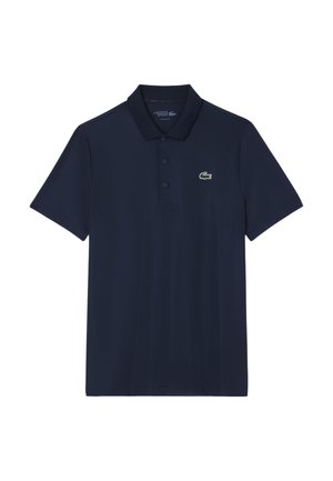 Polo shirt navy in misto cotone con maniche corte, colletto con tre bottoni e un piccolo logo di coccodrillo verde sul lato sinistro del petto.