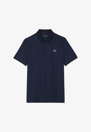 Granatowa koszulka polo z mieszanki bawełny, z krótkimi rękawami, trzema guzikami oraz małym zielonym logo krokodyla na lewej piersi.