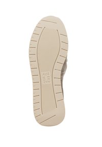 Beige schoenzool met een textuurpatroon voor grip, voorzien van groeven voor tractie. Gemarkeerd met "NATURALIZER" in vette letters aan de zijkant.