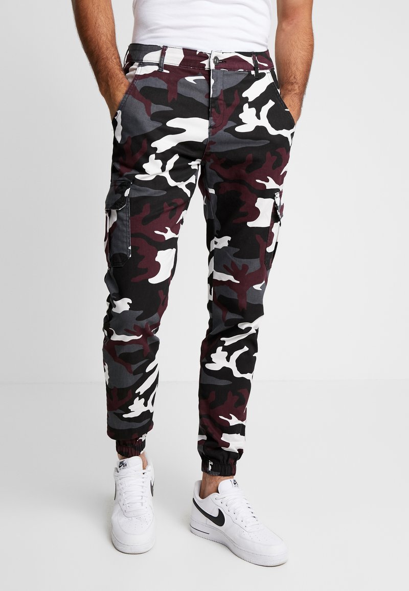 Camo cargo pants in black, white, burgundy, and gray with elastic cuffs and side pockets. Made from durable cotton material.