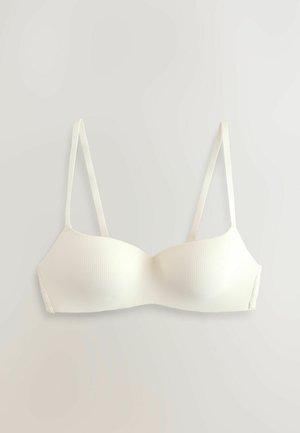 Witte geribde beha met voorgevormde cups en dunne verstelbare bandjes. Heeft een gladde textuur met een naadloos ontwerp en subtiele kanten details aan de zijkant.