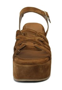 Braune Wildleder-Plateau-Sandale mit gekreuzten Riemen, verstellbarem Knöchelriemen und dickem Fußbett. Glatte Fußbett und flacher Absatz sorgen für Stabilität.