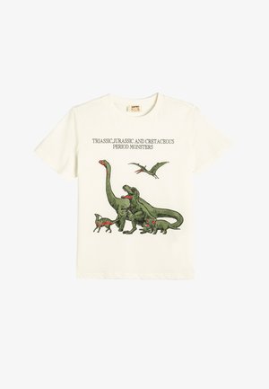 Short-sleeve, cream-colored t-shirt with a dinosaur graphic in greens and reds, featuring text: “Triassic, Jurassic and Cretaceous Period Monsters.”