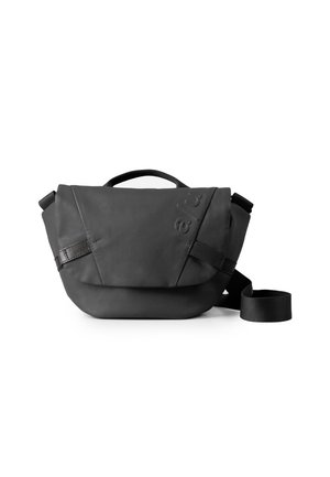 Black shoulder bag made of soft, textured material. Features a fold-over flap, adjustable strap, and embossed logo detail.