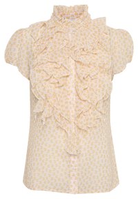 Blouse jaune clair avec un col froncé haut, des manches courtes et des volants superposés sur le devant. Elle présente un tissu à motif de cœurs.