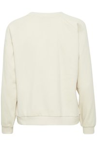 Cream-colored sweatshirt with a crew neck, raglan sleeves, and ribbed cuffs and hem. Soft texture, minimalistic design, no visible patterns.