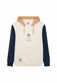 Sudadera con capucha de color beige en la capucha, cuerpo crema y mangas azul marino. Presenta un bolsillo frontal, un diseño gráfico y una etiqueta en la esquina inferior izquierda.