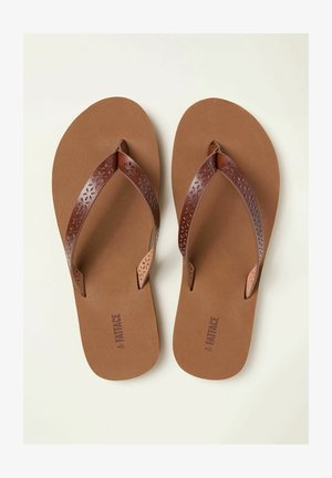 Pruunid plätud tekstuurse tallapadjaga ja dekoratiivsete laserlõigatud rihmadega. Rihmadel on lillemustrid, mis lisavad erilise detaili.