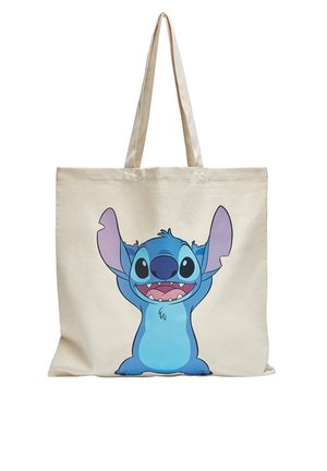 Sac fourre-tout en toile avec un personnage de dessin animé coloré avec de grandes oreilles, de grands yeux et une bouche ouverte montrant les dents sur le devant.