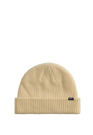 Bonnet en maille couleur crème avec revers replié et petite étiquette noire portant la mention « Vans » sur fond blanc uni.