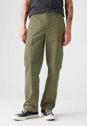 Olive green cargo pants with a relaxed fit, featuring two large side pockets and a flat front, constructed from durable cotton fabric.