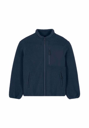 Giacca in pile blu navy con collo alto, chiusura frontale con zip e tessuto strutturato. Presenta una tasca sul petto e due tasche laterali.