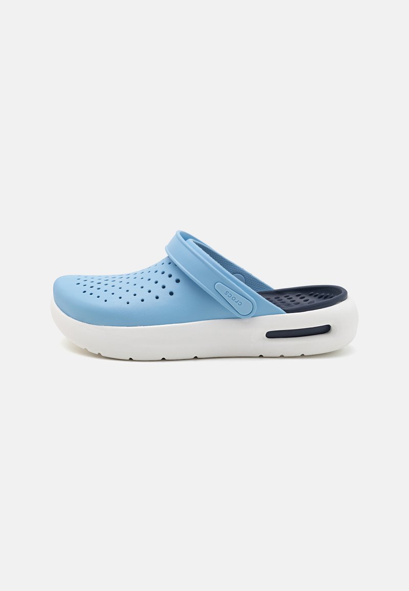 Blue rubber clog with perforations for ventilation, white sole, adjustable strap, and navy interior accents. Designed for comfort and ease.