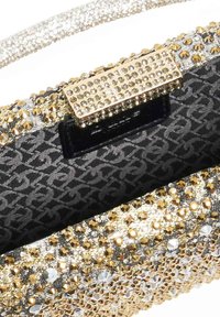 Glittering handbag with gold and silver accents. Features a textured surface adorned with rhinestones. Interior lined in patterned fabric.