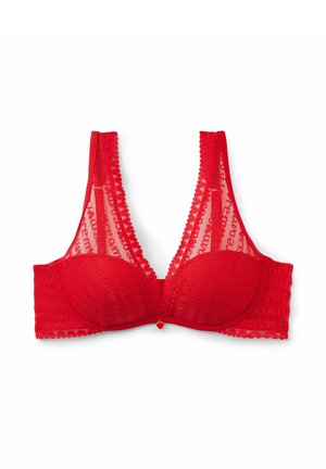 Red lace bra with sheer cups, scalloped edges, and a small heart charm at the center. Features wide straps and a bold, textured pattern.
