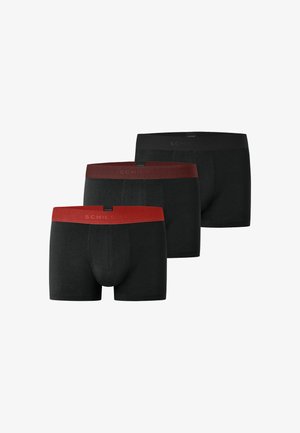 Three black men's boxer briefs with colored waistbands in red, dark red, and black, arranged in a staggered row.