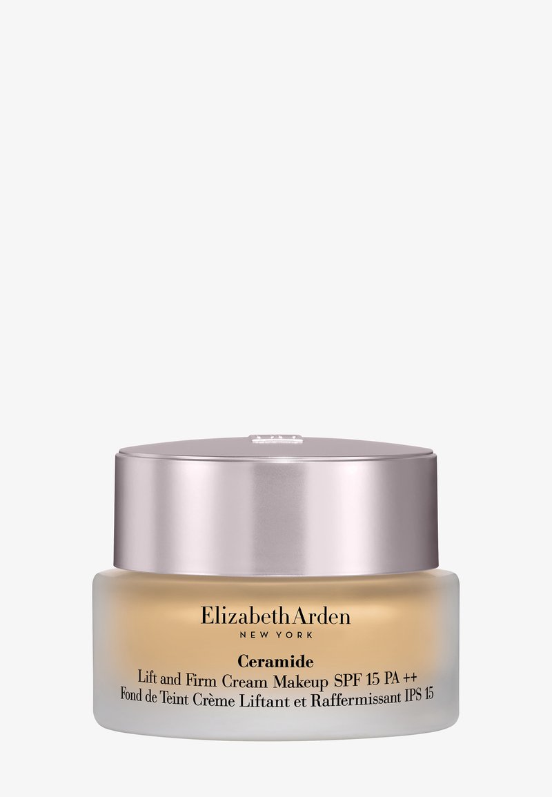 Frasco de crema con maquillaje Elizabeth Arden Ceramide Lift and Firm con SPF 15, base de vidrio esmerilado y tapa brillante de color rosa plateado.
