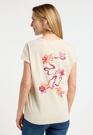 Beige short-sleeve t-shirt with floral design in pink, purple, and orange on the back. Soft cotton fabric, relaxed fit.